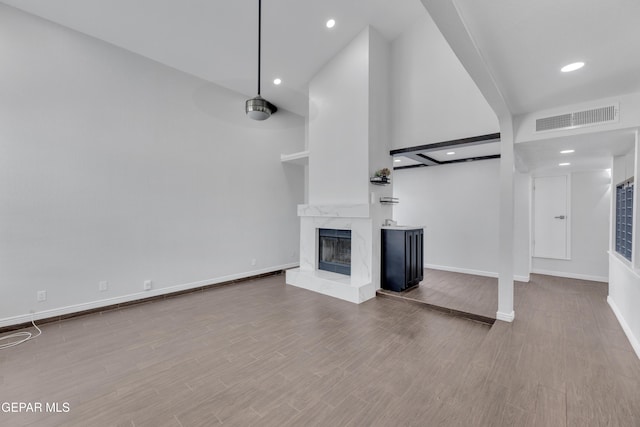 12055 Van Gogh Dr, El Paso, TX 79936 - unfurnished living room featuring a fireplace, baseboards, wood finished floors, and recessed lighting
