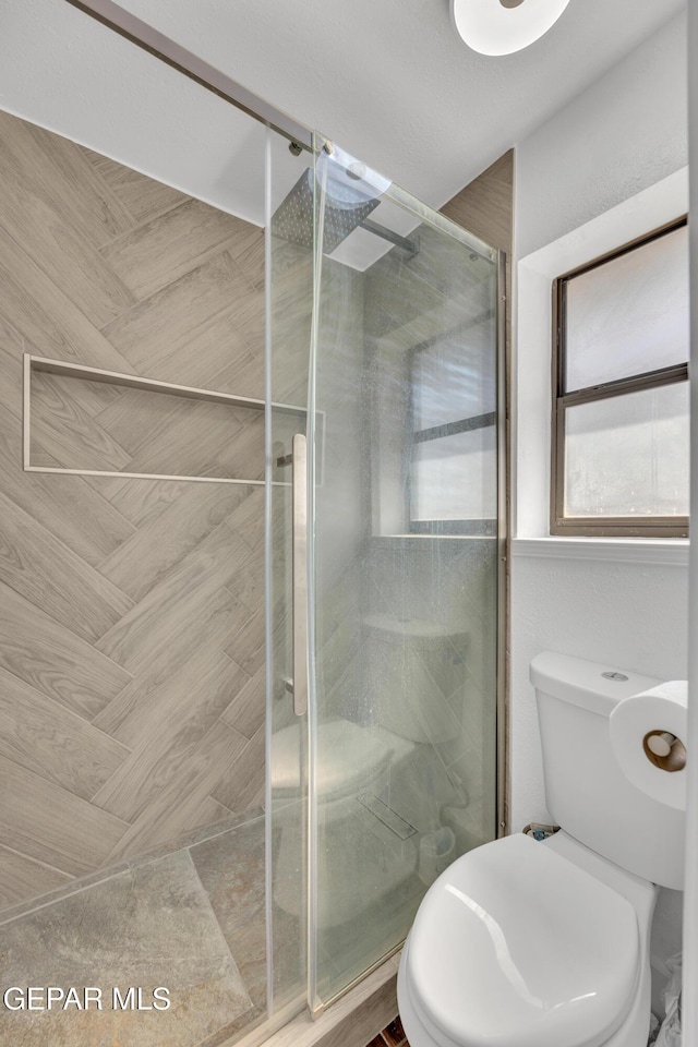 12055 Van Gogh Dr, El Paso, TX 79936 - full bathroom featuring a stall shower and toilet