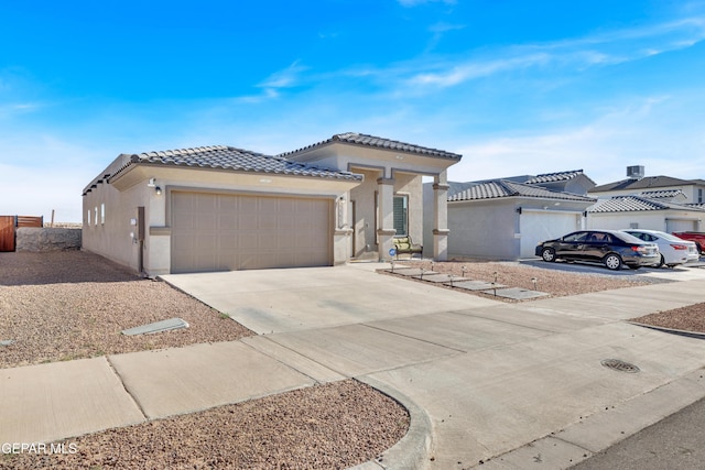 13936 Garforth Ave, El Paso, TX 79928 - view of front of property featuring stucco siding, an attached garage, driveway, and a tiled roof