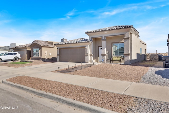 13936 Garforth Ave, El Paso, TX 79928 - view of front of house featuring a tiled roof, stucco siding, a garage, and driveway