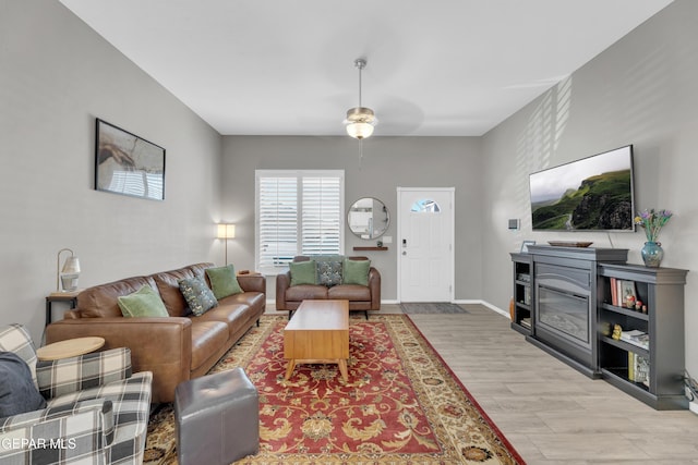 13936 Garforth Ave, El Paso, TX 79928 - living room with light wood-style floors, a ceiling fan, and baseboards