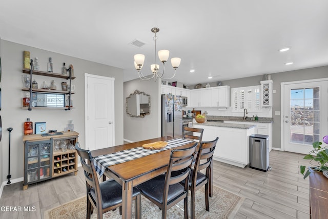 13936 Garforth Ave, El Paso, TX 79928 - dining room featuring a chandelier, recessed lighting, light wood-type flooring, and baseboards