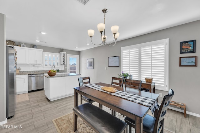 13936 Garforth Ave, El Paso, TX 79928 - dining room with a chandelier, light wood-type flooring, baseboards, and recessed lighting