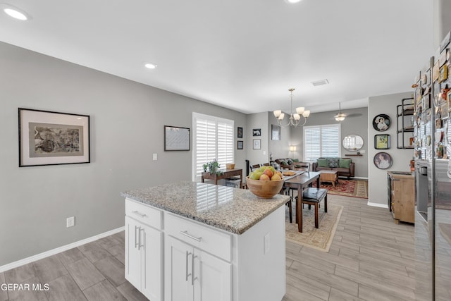 13936 Garforth Ave, El Paso, TX 79928 - kitchen featuring a chandelier, white cabinets, wood tiled floors, a kitchen island, and recessed lighting