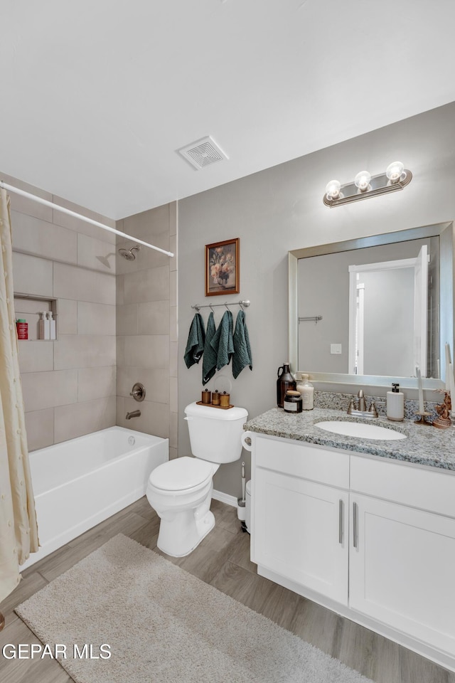 13936 Garforth Ave, El Paso, TX 79928 - bathroom featuring toilet, vanity, shower / bath combo, wood finished floors, and baseboards