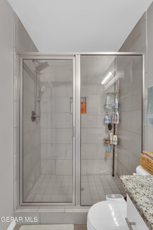 13936 Garforth Ave, El Paso, TX 79928 - bathroom with vanity, a stall shower, and toilet