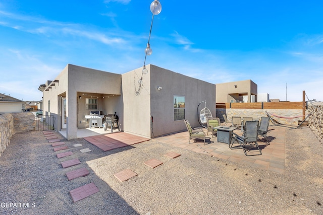 13936 Garforth Ave, El Paso, TX 79928 - back of property featuring an outdoor fire pit, a patio, and stucco siding