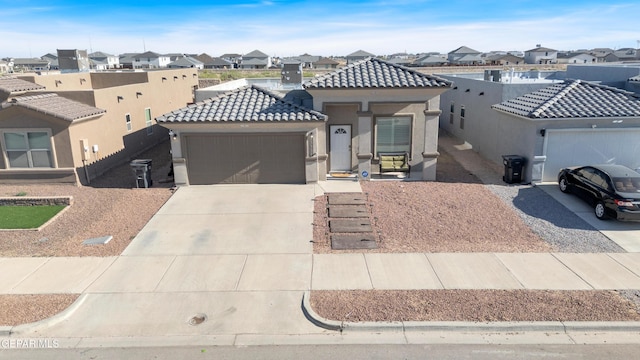 13936 Garforth Ave, El Paso, TX 79928 - view of front of home with a residential view, an attached garage, a tiled roof, stucco siding, and concrete driveway