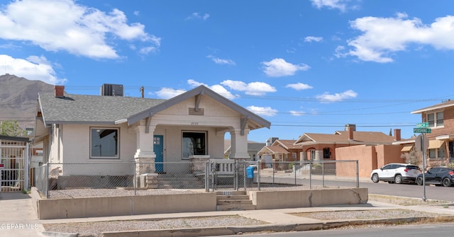 2729 Pershing Dr, El Paso, TX 79903 - view of front of house featuring a gate, brick siding, a fenced front yard, cooling unit, and a shingled roof