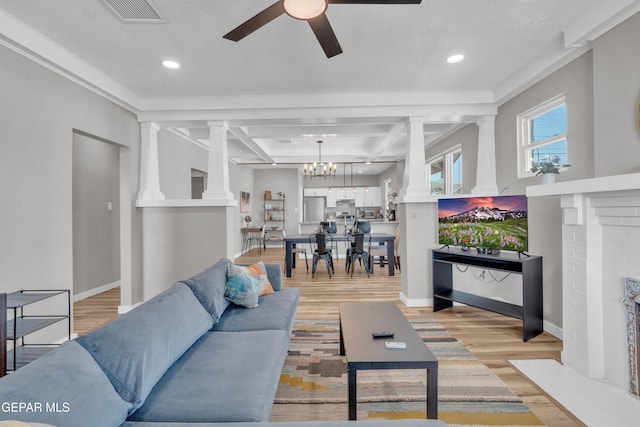 2729 Pershing Dr, El Paso, TX 79903 - living area with ornate columns, light wood-type flooring, a ceiling fan, recessed lighting, and a chandelier
