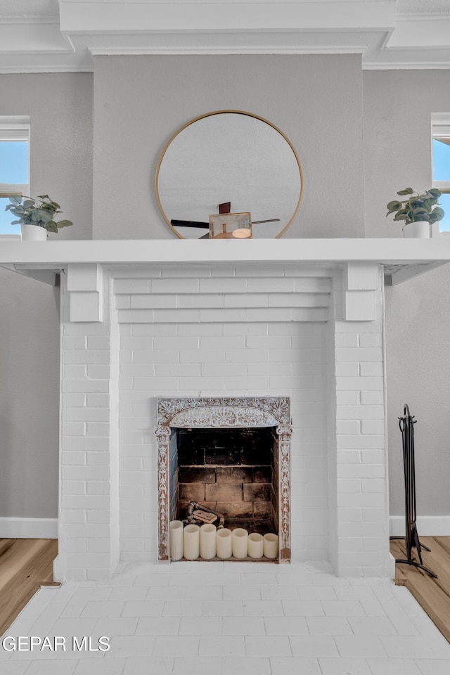 2729 Pershing Dr, El Paso, TX 79903 - detailed view of ornamental molding, a fireplace, wood finished floors, and baseboards