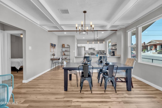 2729 Pershing Dr, El Paso, TX 79903 - dining space featuring coffered ceiling, light wood-type flooring, a chandelier, baseboards, and beamed ceiling