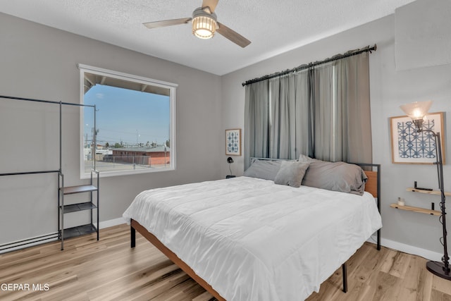 2729 Pershing Dr, El Paso, TX 79903 - bedroom with wood finished floors, baseboards, a textured ceiling, and ceiling fan
