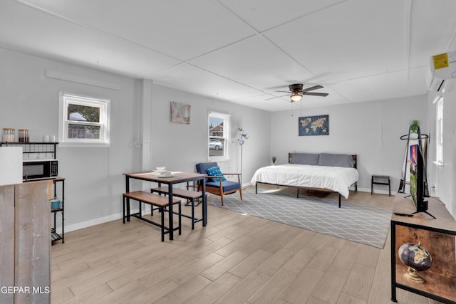 2729 Pershing Dr, El Paso, TX 79903 - bedroom featuring light wood-type flooring, multiple windows, baseboards, and a ceiling fan