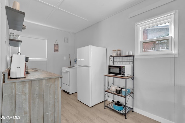 2729 Pershing Dr, El Paso, TX 79903 - kitchen featuring freestanding refrigerator, open shelves, washer / clothes dryer, and light wood-type flooring