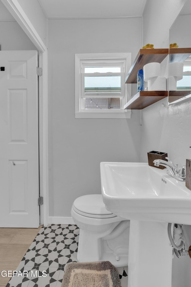 2729 Pershing Dr, El Paso, TX 79903 - half bath with toilet, a sink, tile patterned floors, and baseboards