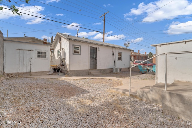 2729 Pershing Dr, El Paso, TX 79903 - rear view of property featuring an outdoor structure, stucco siding, and entry steps