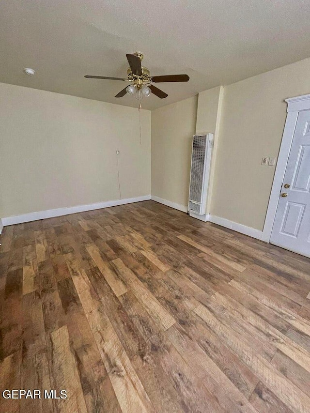 2526 Yandell Dr, El Paso, TX 79903 - empty room featuring wood finished floors, a heating unit, ceiling fan, and baseboards