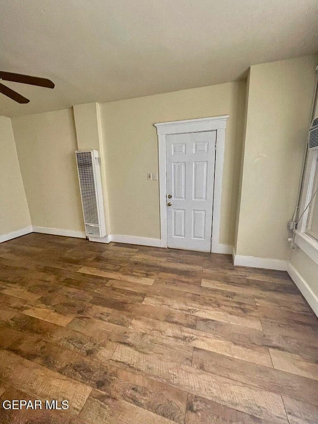 2526 Yandell Dr, El Paso, TX 79903 - spare room with a heating unit, ceiling fan, wood finished floors, and baseboards
