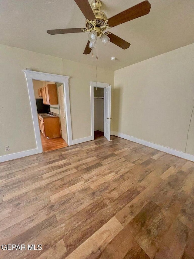 2526 Yandell Dr, El Paso, TX 79903 - unfurnished bedroom with light wood-type flooring, baseboards, ceiling fan, and a closet