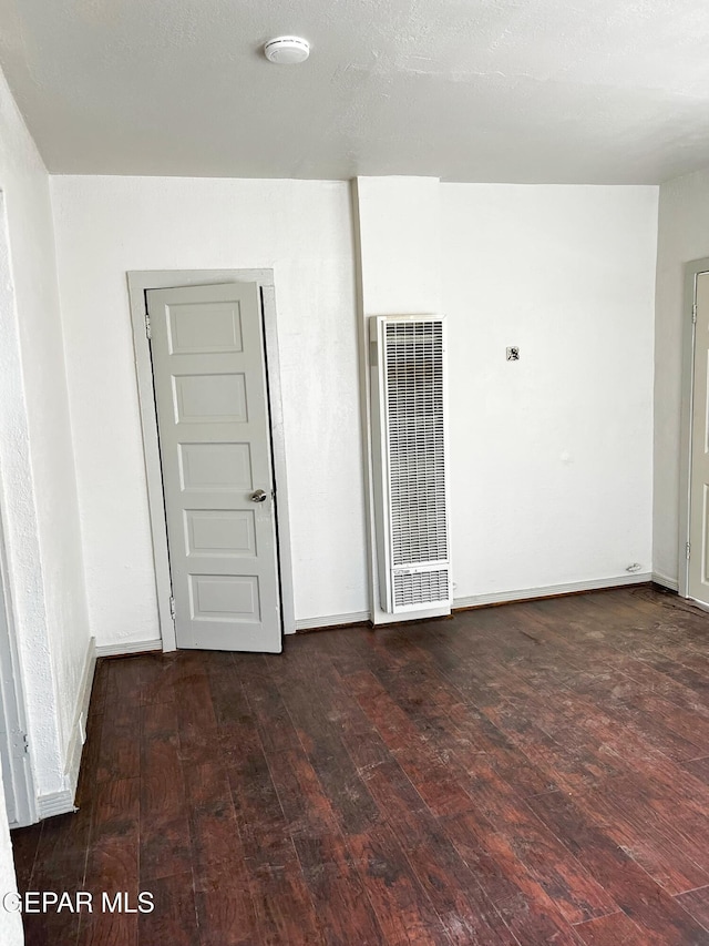 2526 Yandell Dr, El Paso, TX 79903 - empty room featuring a heating unit, wood-type flooring, and baseboards