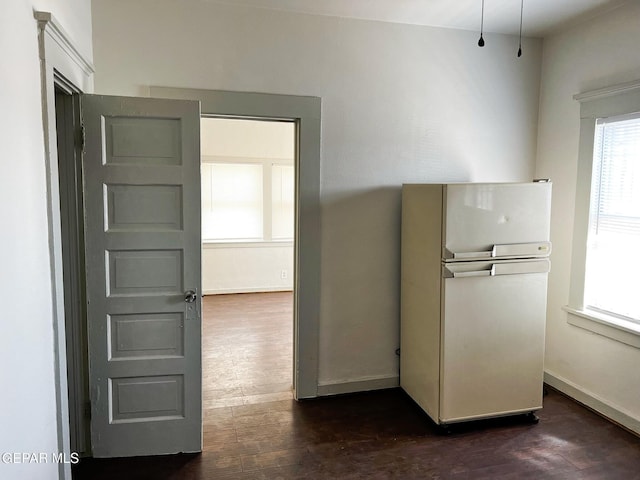 2526 Yandell Dr, El Paso, TX 79903 - kitchen featuring freestanding refrigerator, dark wood-type flooring, and baseboards