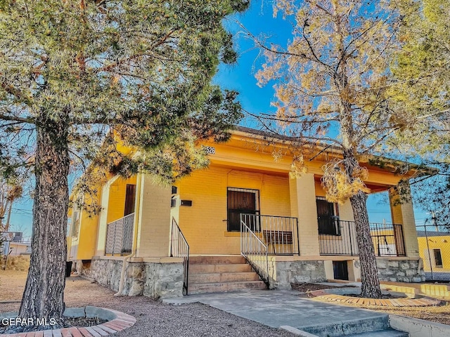 2526 Yandell Dr, El Paso, TX 79903 - view of front of home featuring covered porch, brick siding, and stone siding