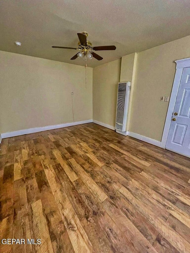 2526 Yandell Dr, El Paso, TX 79903 - unfurnished room with hardwood / wood-style floors, a heating unit, ceiling fan, baseboards, and a smoke detector