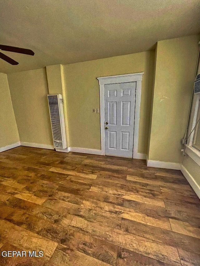 2526 Yandell Dr, El Paso, TX 79903 - entrance foyer featuring a heating unit, dark wood-style floors, ceiling fan, a textured ceiling, and baseboards