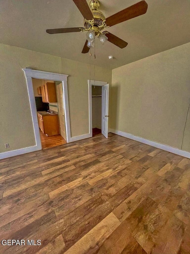 2526 Yandell Dr, El Paso, TX 79903 - unfurnished bedroom featuring wood finished floors, baseboards, a ceiling fan, and a closet