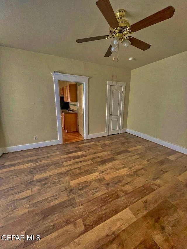 2526 Yandell Dr, El Paso, TX 79903 - unfurnished bedroom with wood finished floors, baseboards, and a ceiling fan