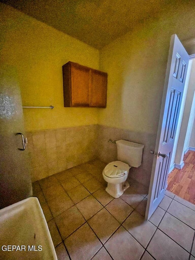 2526 Yandell Dr, El Paso, TX 79903 - bathroom with tile patterned flooring, toilet, and tile walls