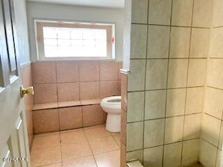 2526 Yandell Dr, El Paso, TX 79903 - full bathroom with toilet, tile patterned floors, and a tile shower