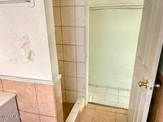 2526 Yandell Dr, El Paso, TX 79903 - bathroom with a shower stall, tile patterned floors, and tile walls