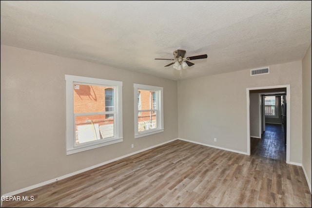 615 Arizona Ave, El Paso, TX 79902 - empty room featuring plenty of natural light, wood finished floors, ceiling fan, and baseboards