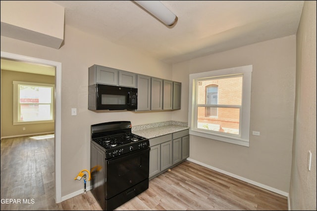 615 Arizona Ave, El Paso, TX 79902 - kitchen with black appliances, gray cabinetry, light wood finished floors, and baseboards