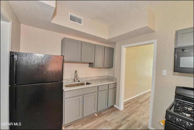 615 Arizona Ave, El Paso, TX 79902 - kitchen featuring black appliances, a sink, and gray cabinets