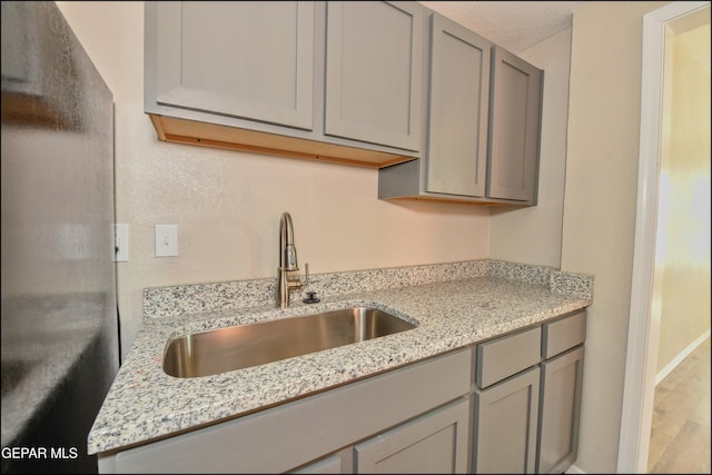 615 Arizona Ave, El Paso, TX 79902 - kitchen featuring a sink, gray cabinetry, and wood finished floors