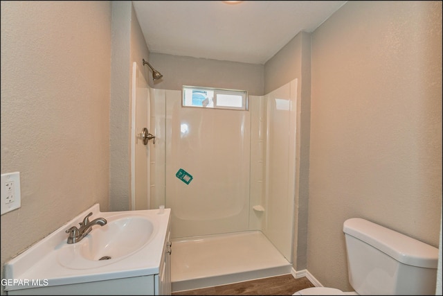 615 Arizona Ave, El Paso, TX 79902 - full bath featuring toilet, a stall shower, vanity, baseboards, and a textured wall