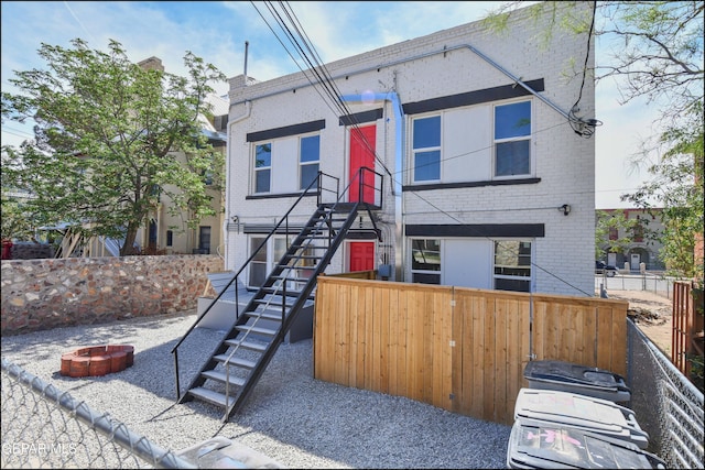 615 Arizona Ave, El Paso, TX 79902 - view of front facade with an outdoor fire pit, brick siding, and stairs