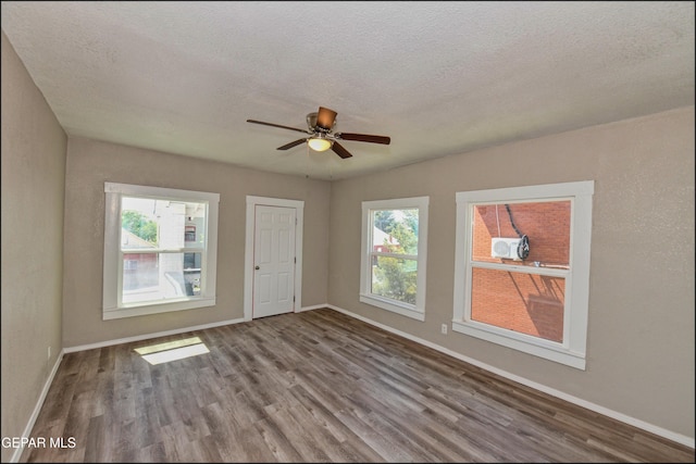 615 Arizona Ave, El Paso, TX 79902 - spare room with wood finished floors, healthy amount of natural light, a ceiling fan, baseboards, and a textured ceiling