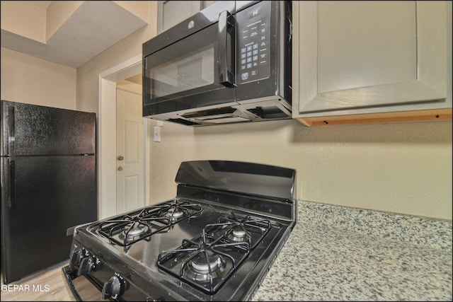 615 Arizona Ave, El Paso, TX 79902 - kitchen with black appliances and light countertops