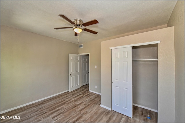 615 Arizona Ave, El Paso, TX 79902 - unfurnished bedroom featuring wood finished floors, a closet, baseboards, ceiling fan, and a textured ceiling