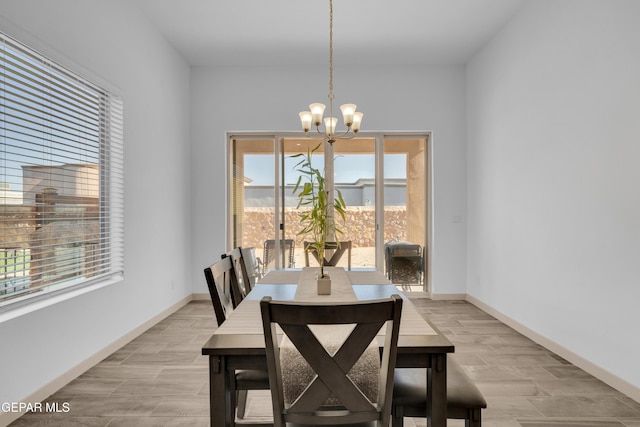 12614 Amesbury, El Paso, TX 79928 - dining area featuring a chandelier, light wood-style floors, and baseboards