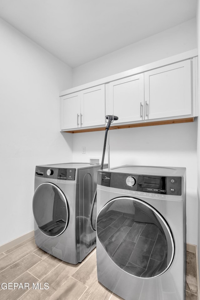 12614 Amesbury, El Paso, TX 79928 - laundry room with cabinet space, separate washer and dryer, light wood-style floors, and baseboards