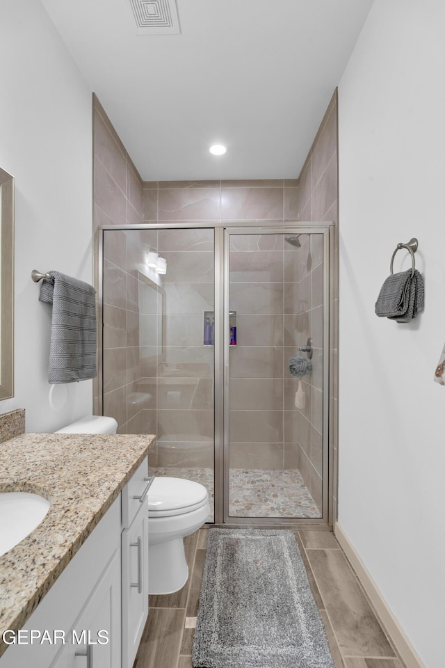 12614 Amesbury, El Paso, TX 79928 - full bath featuring vanity, toilet, a shower stall, wood finish floors, and recessed lighting