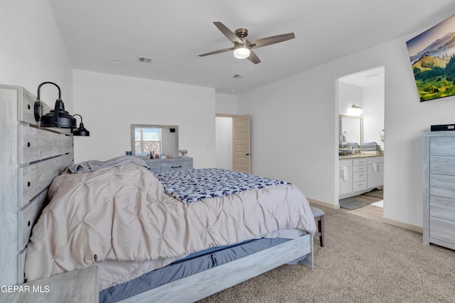 12614 Amesbury, El Paso, TX 79928 - bedroom with light carpet, ceiling fan, ensuite bath, and baseboards