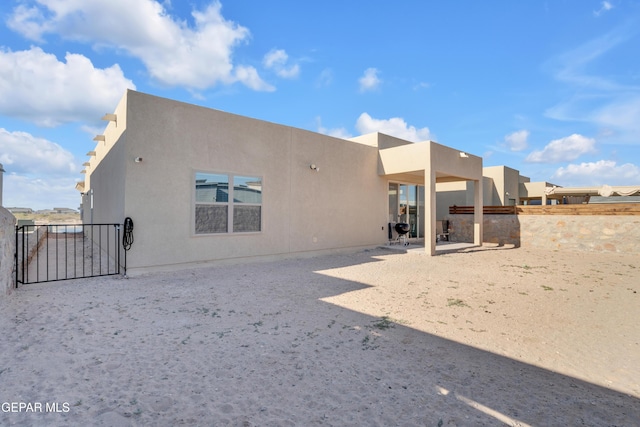 12614 Amesbury, El Paso, TX 79928 - back of house featuring stucco siding and a patio area