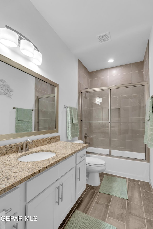 12614 Amesbury, El Paso, TX 79928 - bathroom with vanity, toilet, and combined bath / shower with glass door