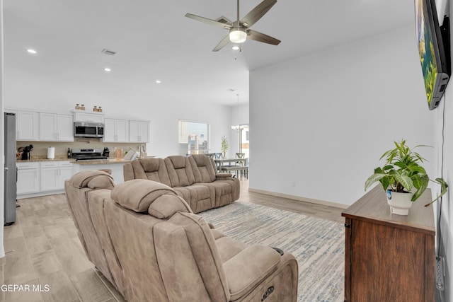 12614 Amesbury, El Paso, TX 79928 - living room with recessed lighting, ceiling fan, a chandelier, light wood-style floors, and baseboards